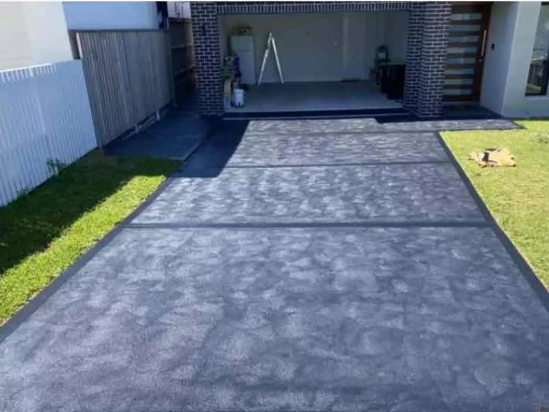coloured concrete driveway finish at this home in Curl Curl