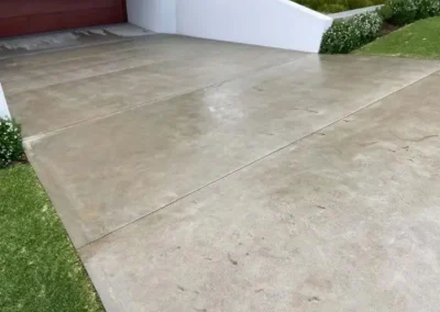 Concrete driveway in Freshwater with scored panels leading up to a garage