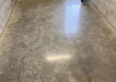 Polished concrete flooring in Dee Why with a mottled finish between bare concrete walls