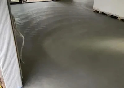 Polished concrete flooring in Newport curing in a construction site before fit-out
